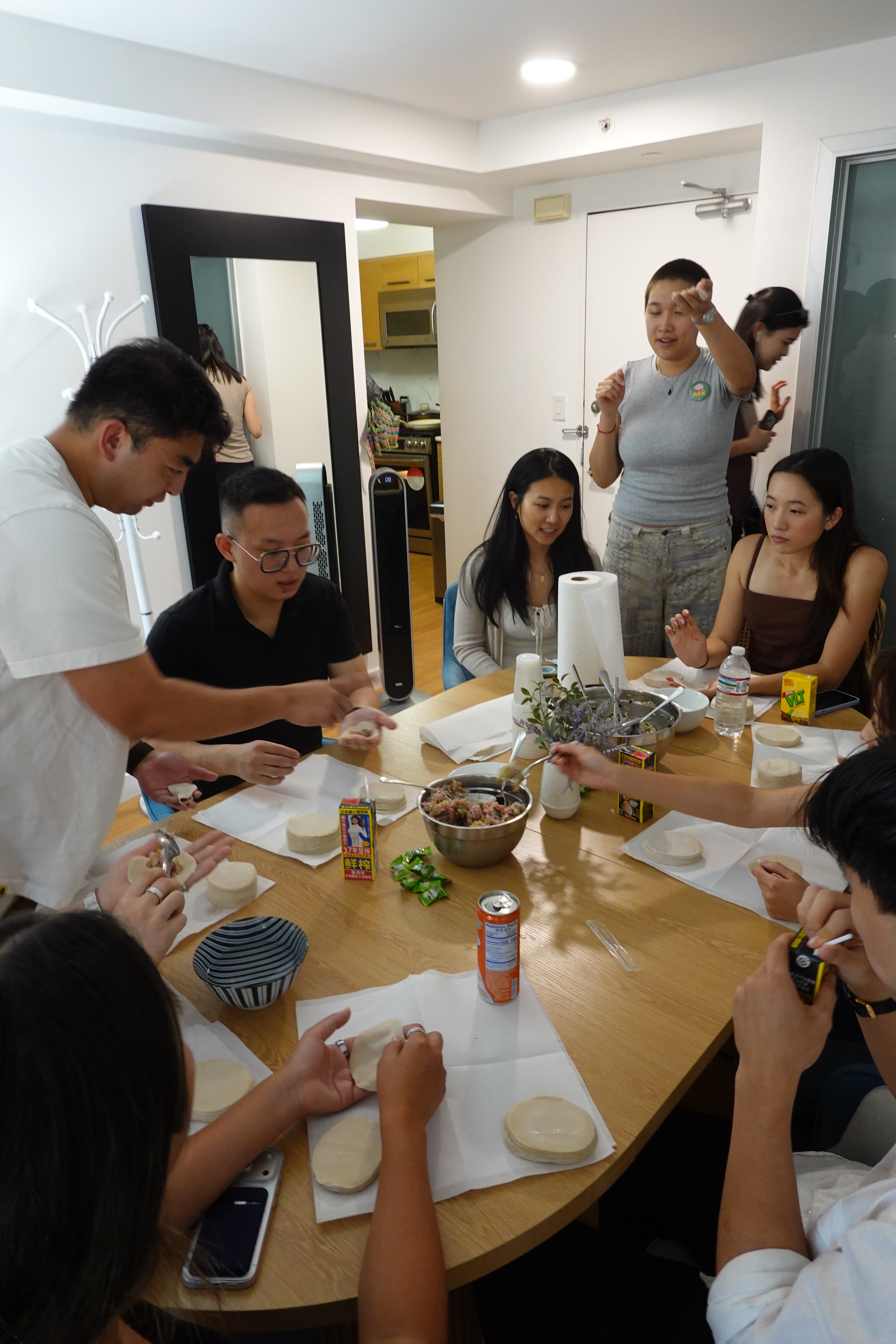 Guests learning to fold dumplings together